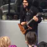 Coheed And Cambria Frontman Busks For Kindergarteners, "Eraser" Lyric Video Posted