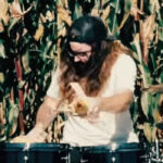 Man Covers Korn With Corn In A Cornfield