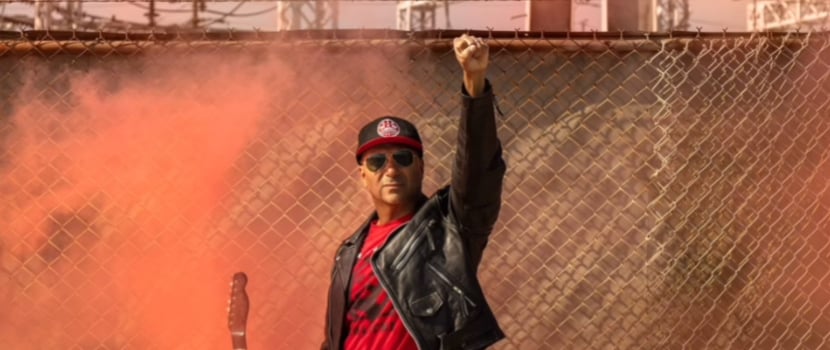 Embodying defiance, Tom Morello raises a fist